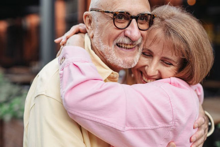 seniors hugging each other