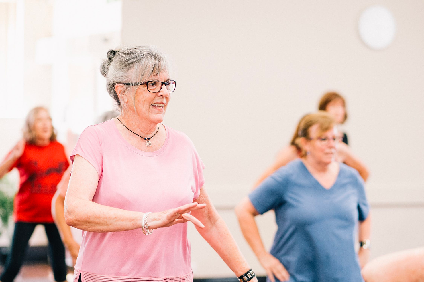 seniors being active in a group class